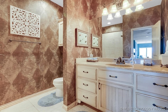 bathroom with tile patterned flooring, toilet, and vanity