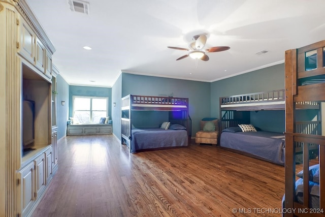 bedroom with ceiling fan, hardwood / wood-style floors, and ornamental molding