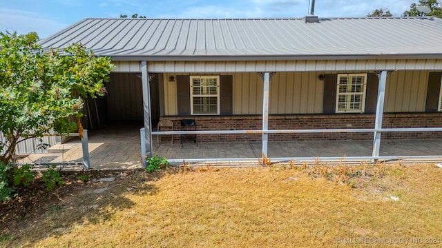 rear view of house with a yard and a carport