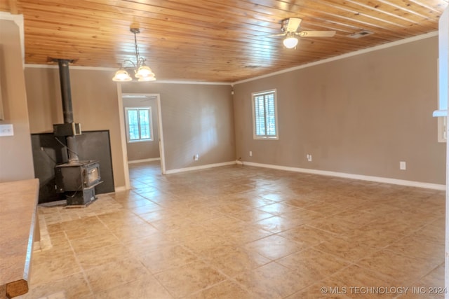 unfurnished living room with ceiling fan with notable chandelier, a wood stove, ornamental molding, and wooden ceiling