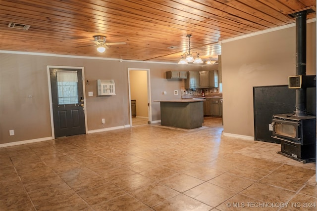 unfurnished living room featuring a wood stove, ceiling fan, ornamental molding, and wood ceiling