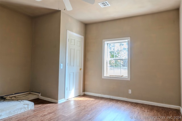 unfurnished room with ceiling fan and hardwood / wood-style floors