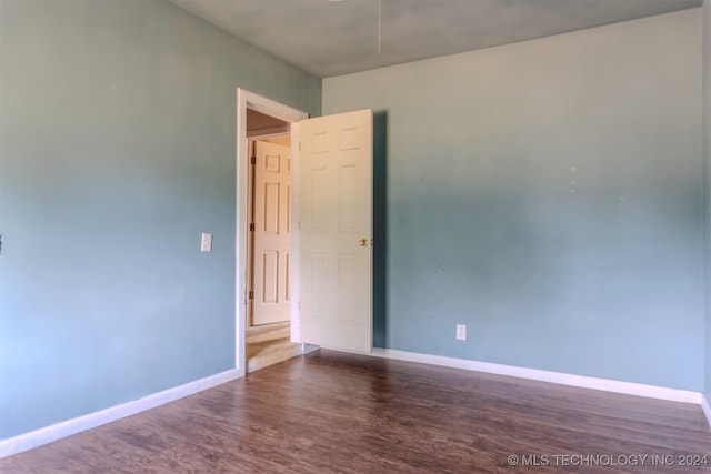 empty room with dark wood-type flooring