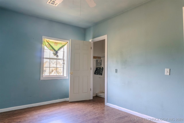 unfurnished room with hardwood / wood-style floors and ceiling fan