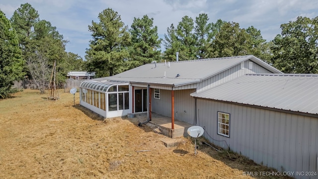 back of property with a sunroom