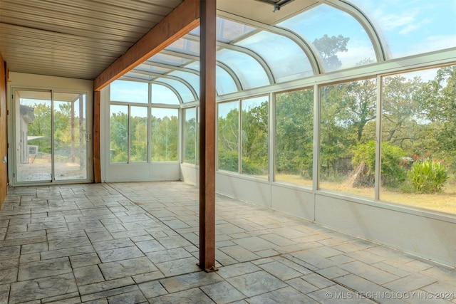 unfurnished sunroom featuring a healthy amount of sunlight