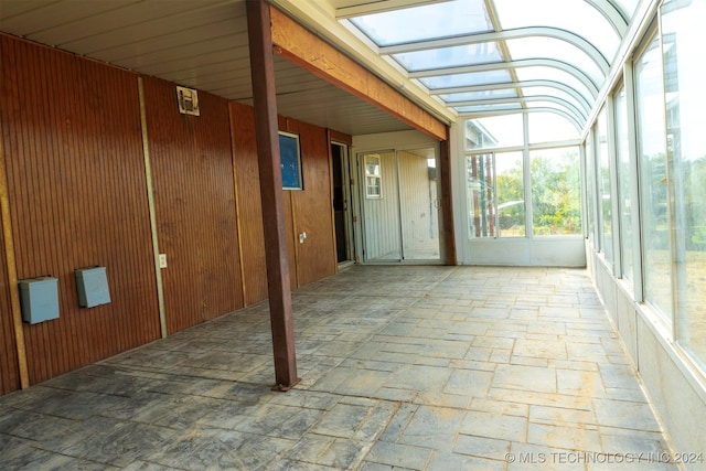 unfurnished sunroom featuring a skylight