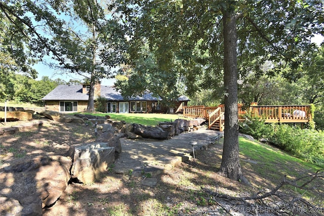 view of yard with a wooden deck