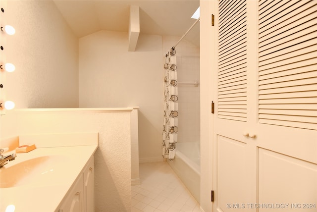 bathroom with tile patterned flooring, vanity, and shower / tub combo