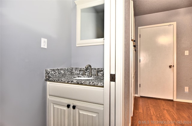 bathroom featuring vanity and wood finished floors