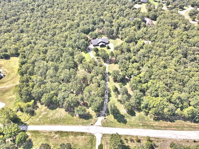 birds eye view of property featuring a view of trees