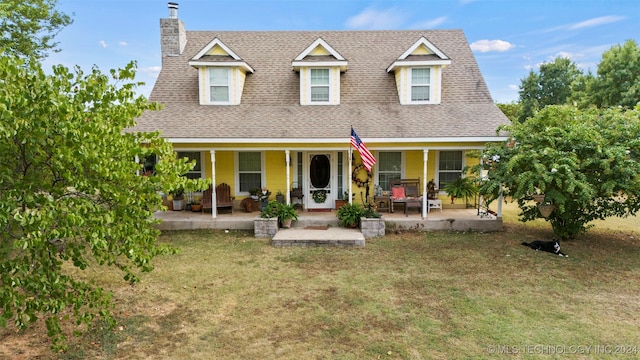 exterior space with a front lawn and covered porch