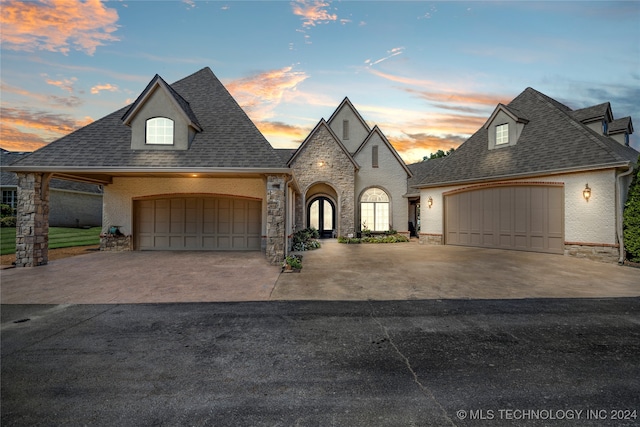 french country style house featuring a garage