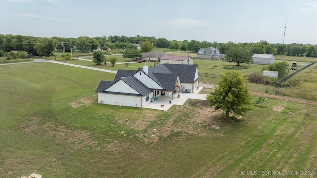 birds eye view of property featuring a rural view