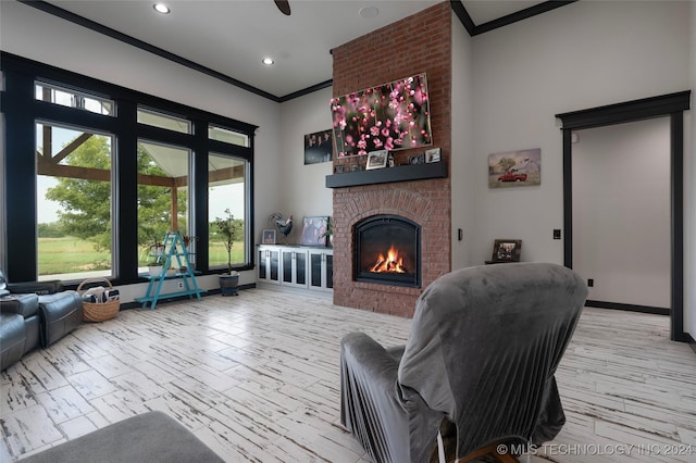 living room with baseboards, recessed lighting, a fireplace, and crown molding