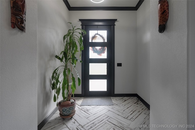 entrance foyer featuring ornamental molding and light parquet flooring