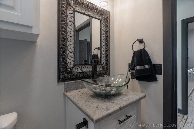 bathroom featuring toilet and vanity