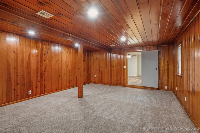 basement featuring carpet flooring, wooden walls, and wooden ceiling