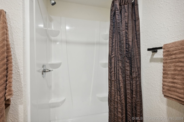 bathroom with a shower with curtain