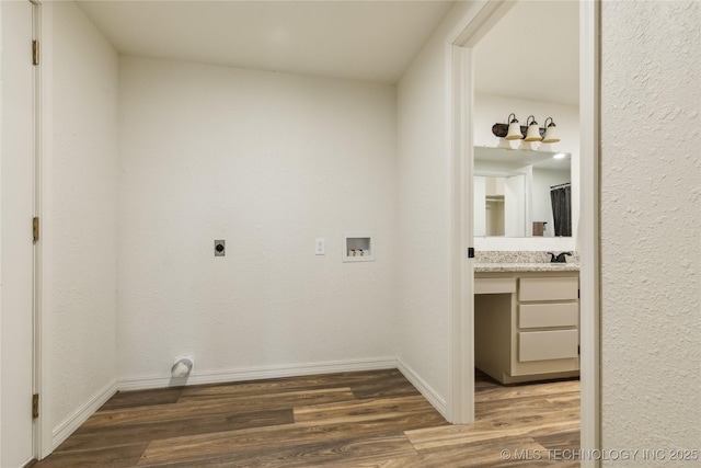 laundry room with electric dryer hookup, baseboards, wood finished floors, and hookup for a washing machine