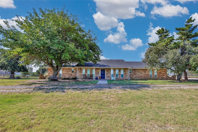 ranch-style home with a front lawn