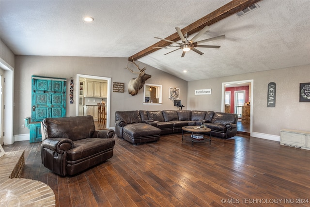 living room featuring lofted ceiling with beams, dark hardwood / wood-style floors, ceiling fan, and a textured ceiling