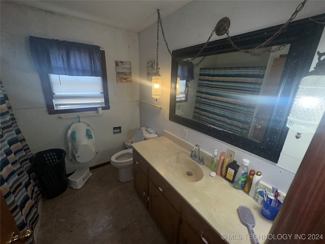 bathroom featuring toilet, a shower with shower curtain, vanity, and tile patterned floors