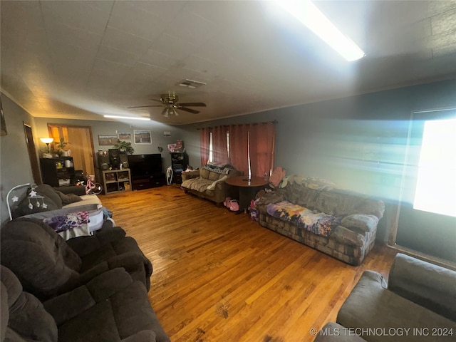 living room featuring ceiling fan and hardwood / wood-style flooring