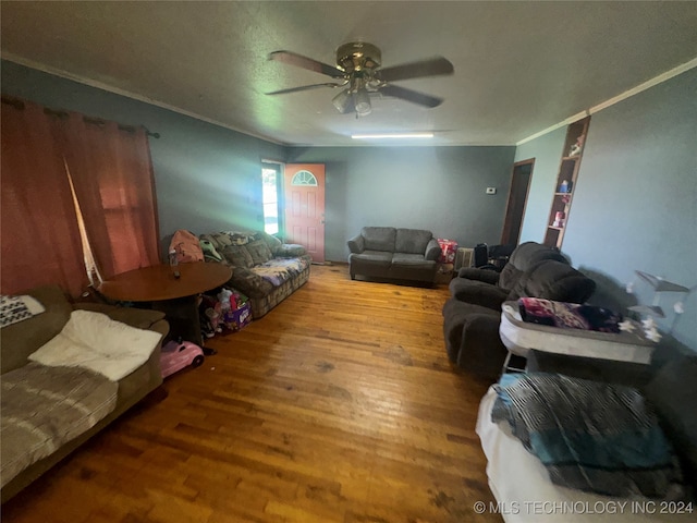 living room featuring hardwood / wood-style flooring, ceiling fan, and ornamental molding