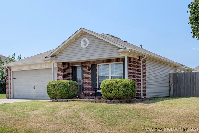 ranch-style house featuring a front lawn and a garage