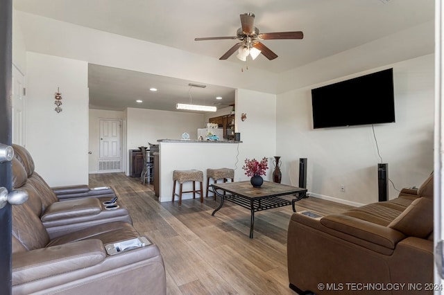 living room with ceiling fan and hardwood / wood-style floors