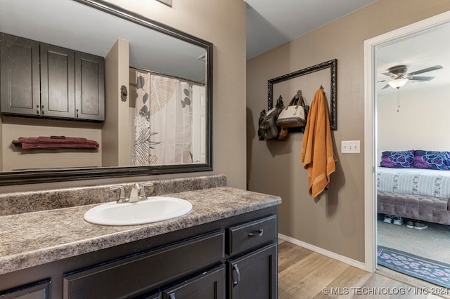 bathroom featuring ceiling fan, vanity, and hardwood / wood-style floors