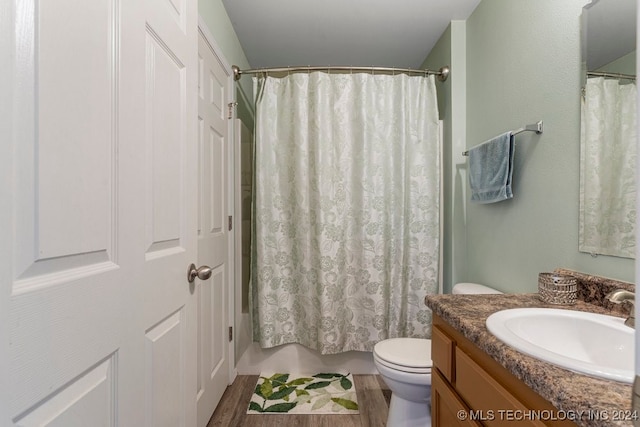 bathroom with a shower with shower curtain, toilet, vanity, and wood-type flooring