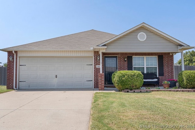 ranch-style home featuring a garage and a front lawn