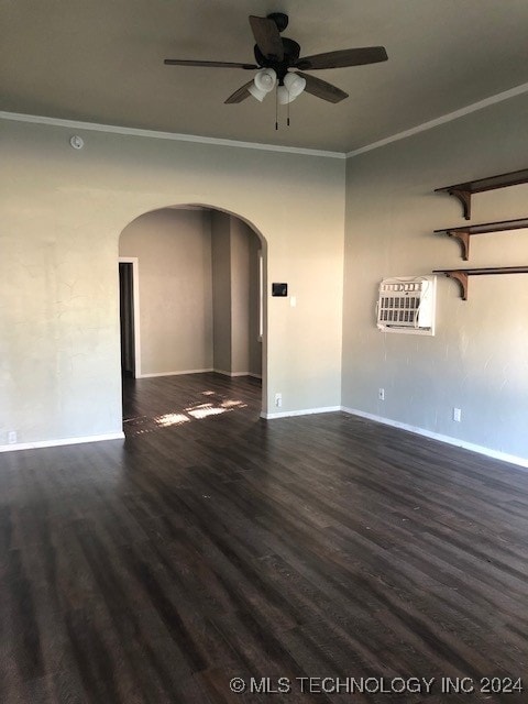 spare room featuring dark wood-type flooring, ceiling fan, and ornamental molding