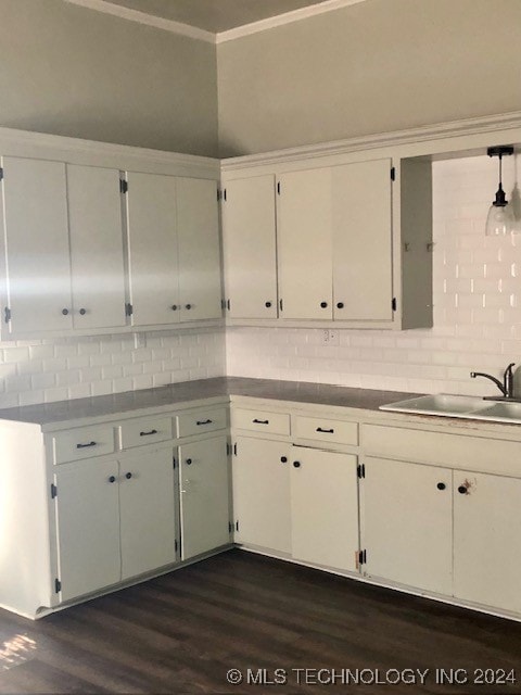 kitchen with white cabinetry, sink, decorative backsplash, and dark hardwood / wood-style floors