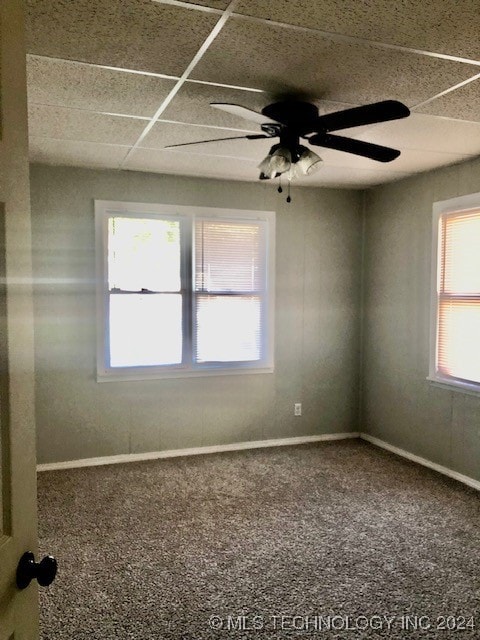 carpeted empty room with ceiling fan and plenty of natural light