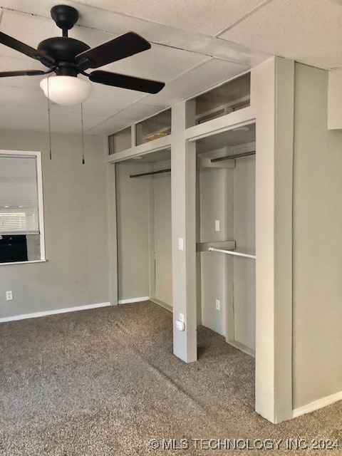 unfurnished bedroom with ceiling fan and carpet