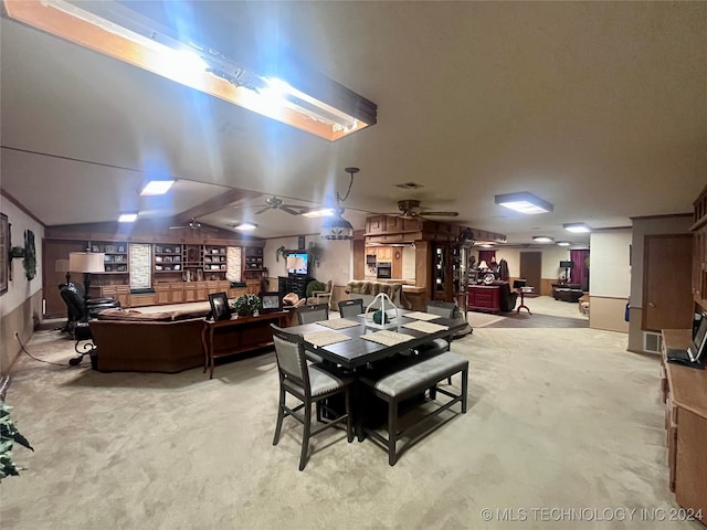 carpeted dining room featuring vaulted ceiling and ceiling fan