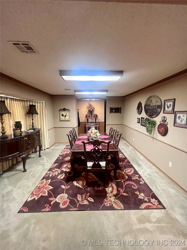 carpeted dining area featuring crown molding and a textured ceiling