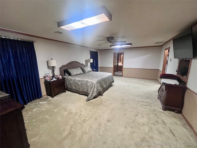 carpeted bedroom with crown molding, a textured ceiling, and ceiling fan