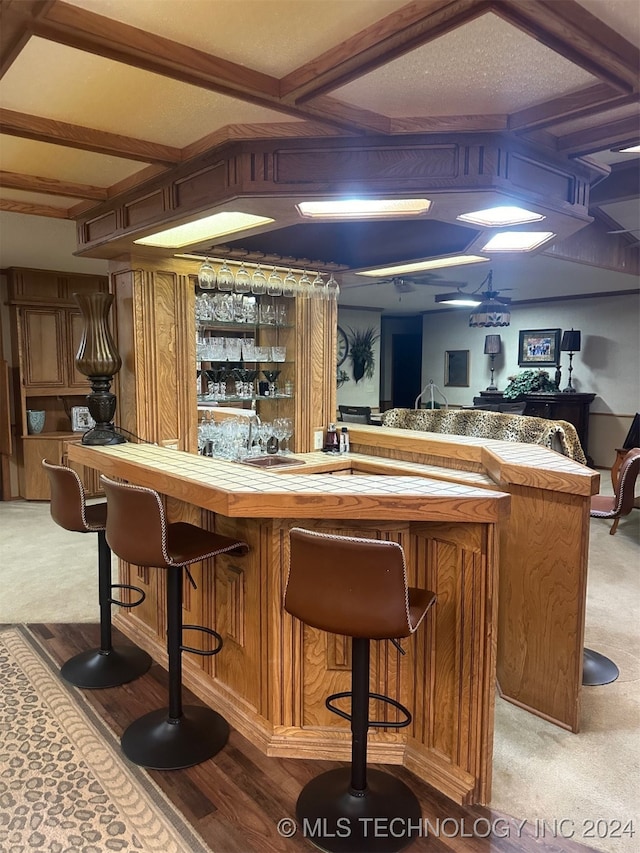 bar featuring beam ceiling, a textured ceiling, and carpet floors