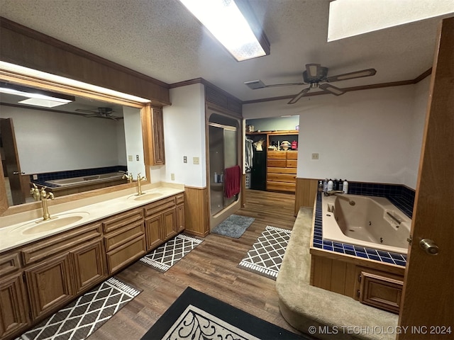 bathroom featuring separate shower and tub, crown molding, hardwood / wood-style floors, vanity, and a textured ceiling