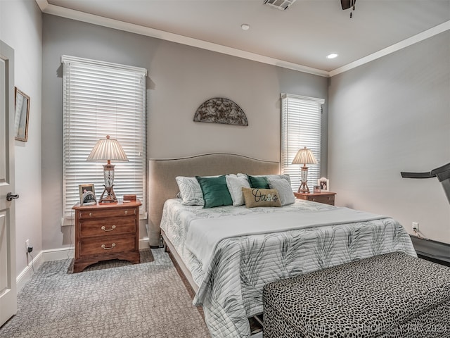 carpeted bedroom with ornamental molding