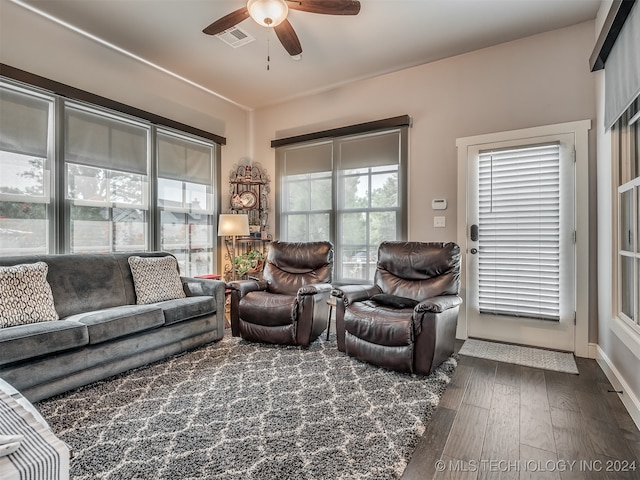 living room with ceiling fan and dark hardwood / wood-style flooring