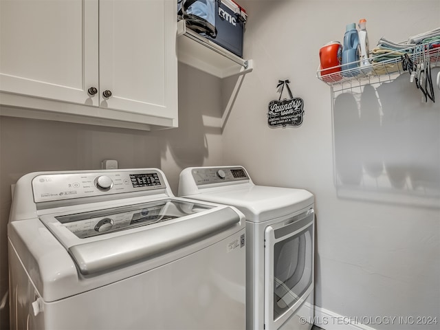 clothes washing area featuring cabinets and independent washer and dryer