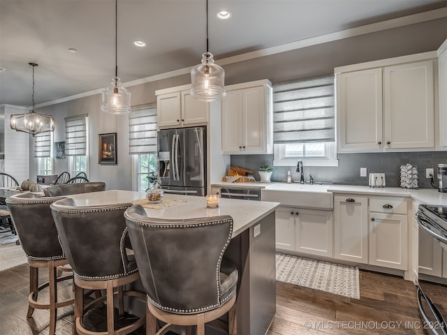 kitchen with white cabinetry, stainless steel fridge with ice dispenser, and pendant lighting