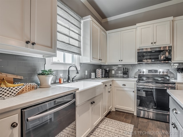 kitchen featuring sink, dark wood-type flooring, stainless steel appliances, backsplash, and white cabinets