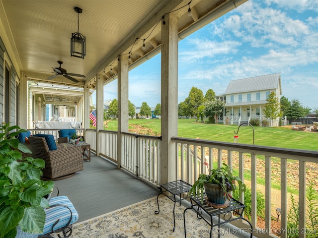 balcony featuring covered porch and ceiling fan