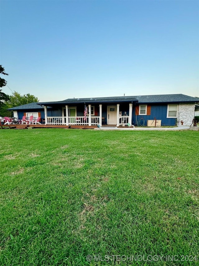 view of front facade featuring a wooden deck and a front lawn